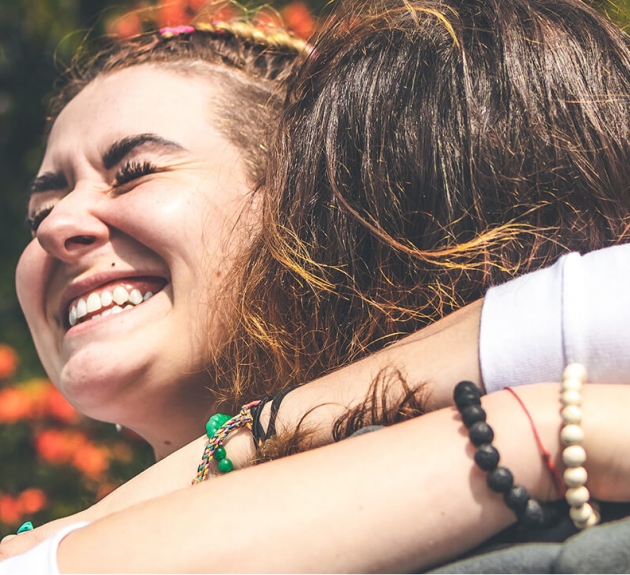 Duo d'amies souriantes qui se serrent dans leurs bras
