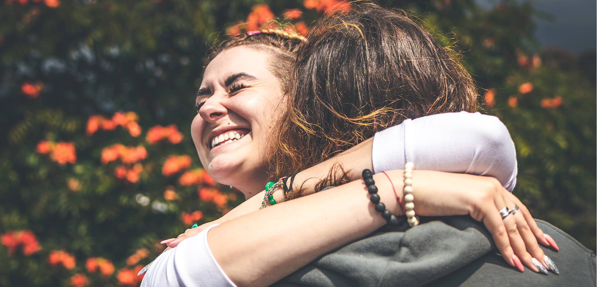 Deux amies souriantes qui se serrent dans leurs bras